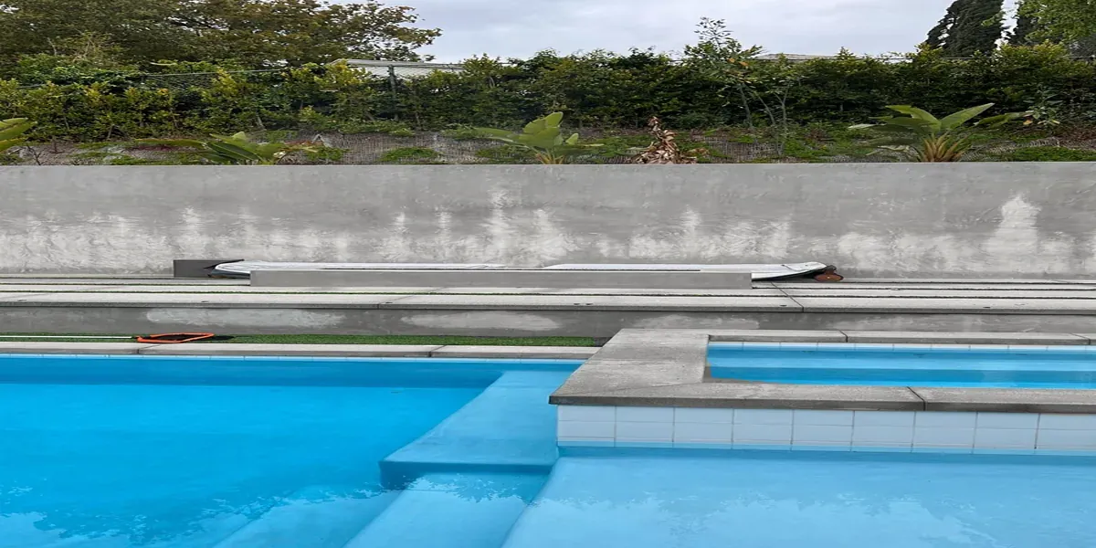 Modern gunite pool with travertine deck