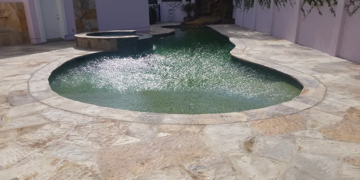 Compact plunge pool with stone deck for small urban lot in Santa Monica
